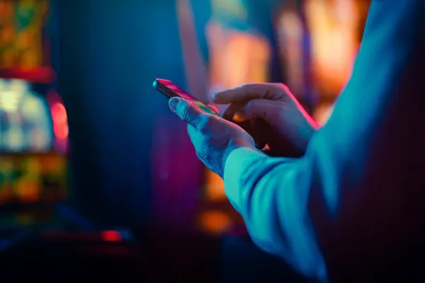 A woman in a luxurious green gown next to an ornate roulette wheel, capturing the upscale casino mood of ZBZBET.