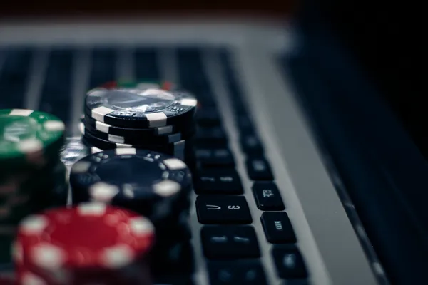 A dramatic shot of winning sevens landing on a slot reel surrounded by shining gold coins, symbolizing big wins.